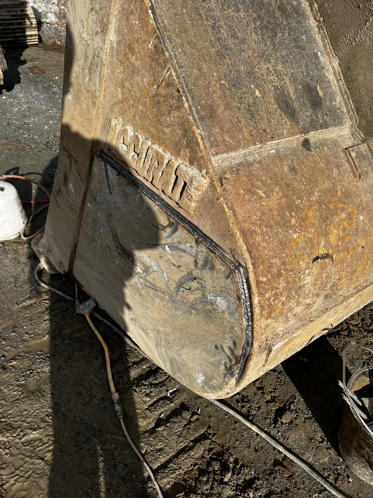 CWB certified structural welder on Caterpillar heavy equipment — field structural welding in BC